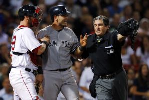 New York Yankees&#039; Cervelli is held back by Boston Red Sox&#039;s Saltalamacchia and home plate umpire Capuano after getting hit by a pitch during their MLB American League baseball game in Boston