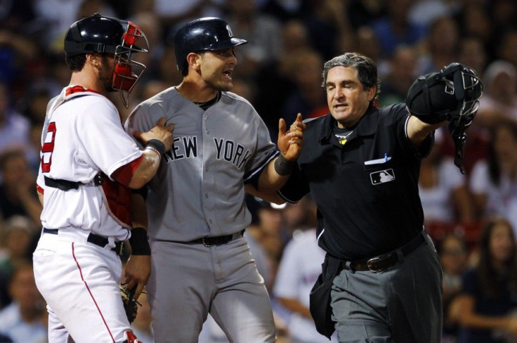 New York Yankees&#039; Cervelli is held back by Boston Red Sox&#039;s Saltalamacchia and home plate umpire Capuano after getting hit by a pitch during their MLB American League baseball game in Boston