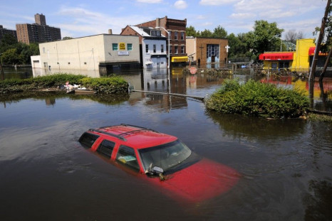 Flood waters from the Passaic River fill the streets covering automobiles including a Chevrolet SUV days after Hurricane Irene in Paterson, New Jersey