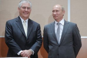 Russian Prime Minister Putin and Exxon CEO Tillerson look on at a signing ceremony in the Black Sea resort of Sochi