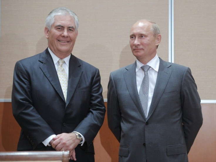 Russian Prime Minister Putin and Exxon CEO Tillerson look on at a signing ceremony in the Black Sea resort of Sochi