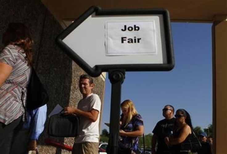 People wait in line to enter a job fair at the Phoenix Workforce Connection in Phoenix