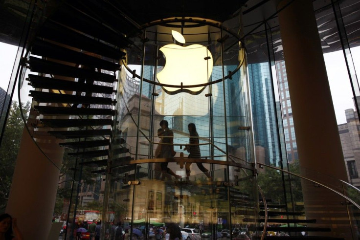 People walk inside an Apple retail store in Shanghai