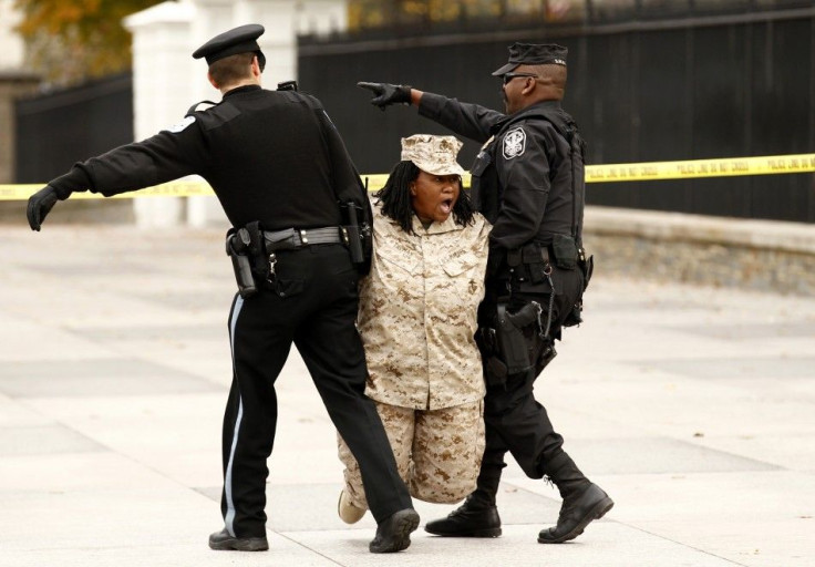 Veteran Evelyn Thomas is arrested after handcuffing herself to a fence at the White House in Washington