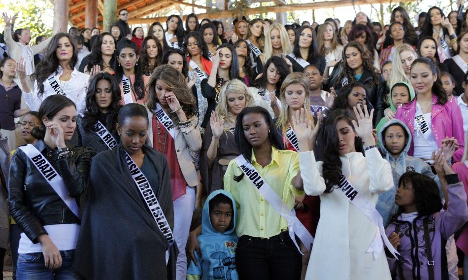 Miss Universe 2011 contestants attend a welcoming ceremony as they arrive at Alianca Misericordia non-profit catholic organization in the outskirts of Sao Paulo 