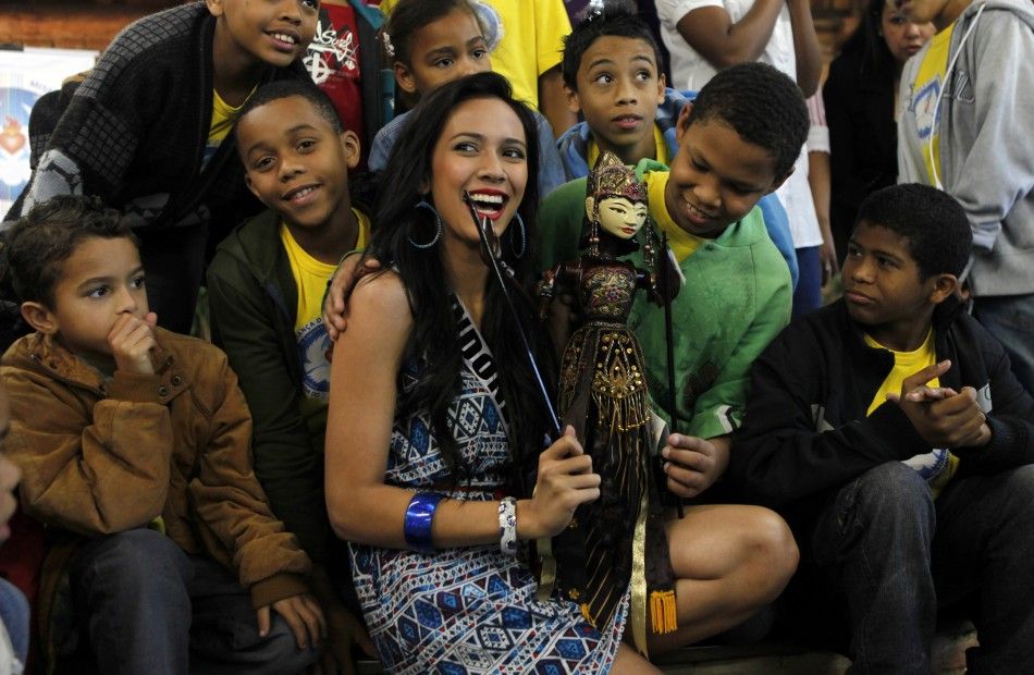 Miss Indonesia Nadine Alexandra poses with children at the Alianca Misericordia non-profit Catholic organisation in the outskirts of Sao Paulo 