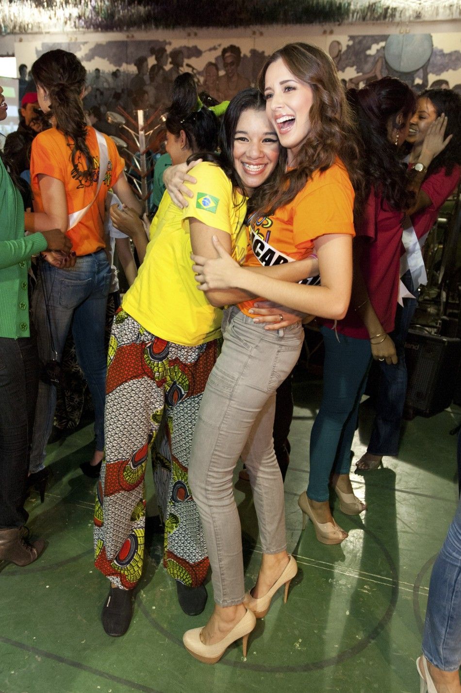 Miss Nicaragua Adriana Dom hugs a girl after joining dancers in a performance at Meninos do Morumbi social project in Sao Paulo 