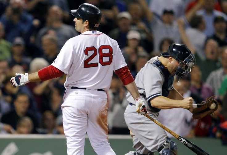 The Boston Red Sox Adrian Gonzalez (L) and New York Yankees catcher Russell Martin react after Gonzalez struck out to end their MLB American League baseball game at Fenway Park in Boston