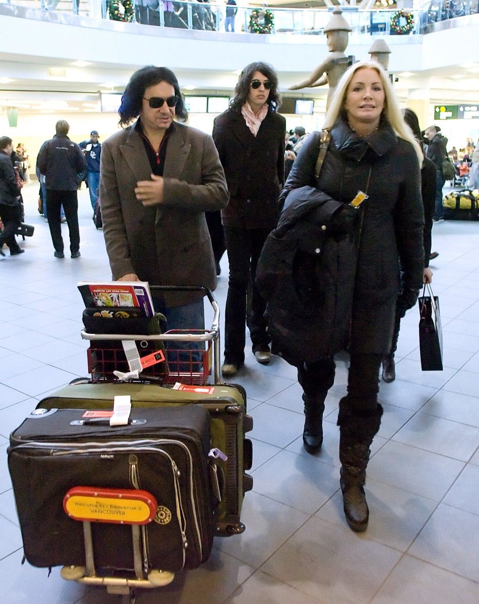 Rock Star Gene Simmons L accompanied his partner Shannon Tweed R and son Nick arrive in Vancouver, British Columbia December 29, 2008. The family were heading to the ski resort of Whistler.
