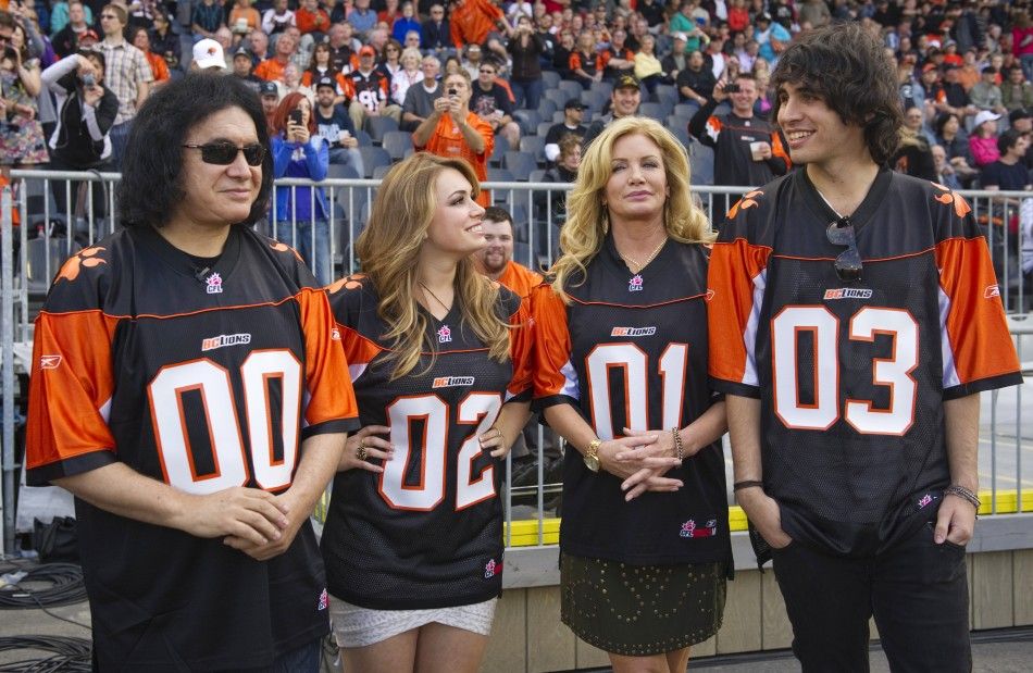 Gene Simmons of the band Kiss and his common-law spouse Shannon Tweed 2nd R along with their children Sophie and Nick R stand on the sidelines before the the CFL football game between the BC Lions and Hamilton Tiger-Cats in Vancouver, British Columbia