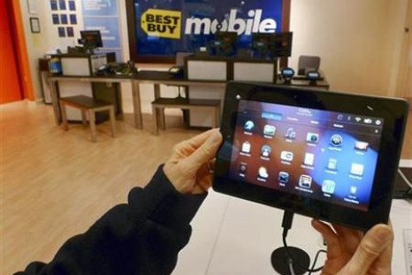 A customer holds a Research In Motion&#039;s PlayBook tablet computer in Fairfax