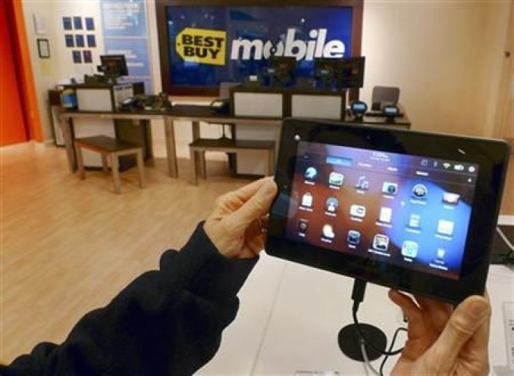 A customer holds a Research In Motion&#039;s PlayBook tablet computer in Fairfax