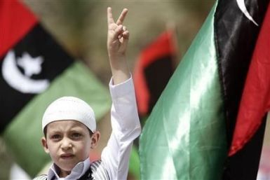 Libyans pledge democracy as they win Gaddafi billions
