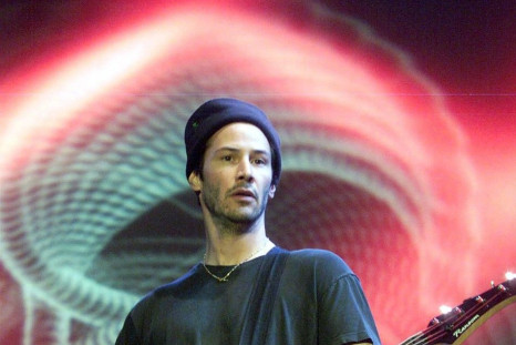Hollywood actor Keanu Reeves plays the bass guitar during a concert performance by his band &quot;Dogstar&quot; at Huamark Staduim in Bangkok, Thailand 