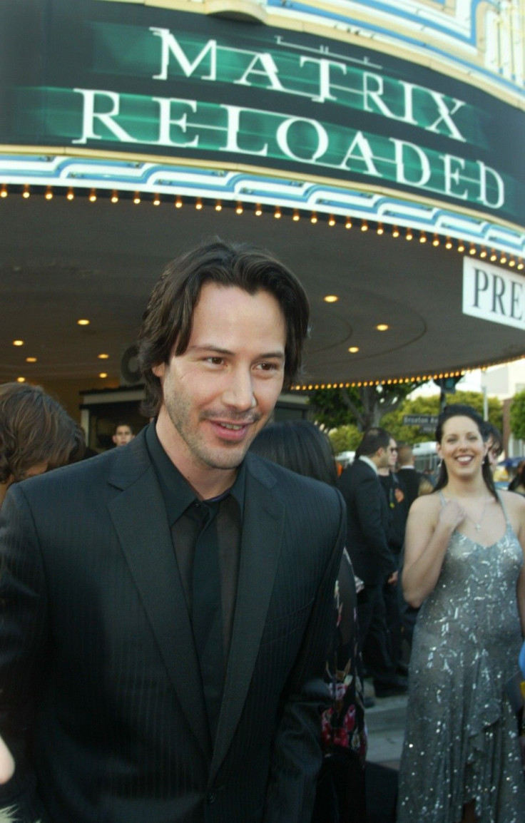 Actor Keanu Reeves star of the new film &quot;The Matrix Reloaded&quot; poses with the theater marquee behind him at the film's premiere in Los Angeles
