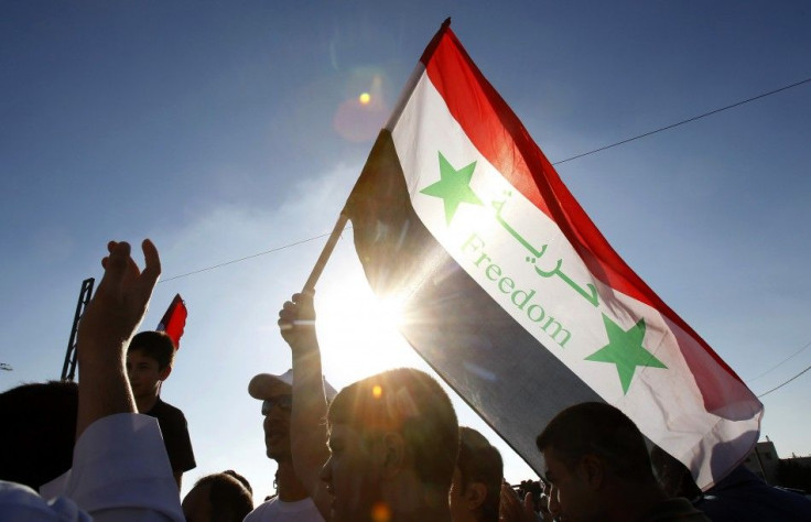 Syrians living in Jordan shout slogans against Syrian President Bashar al-Assad after morning prayers on the first day of Eid Al-Fitr outside the Syrian embassy in Amman