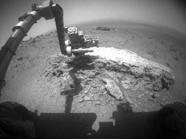 NASA's Mars Exploration Rover Opportunity used its front hazard-avoidance camera to take this picture showing the rover's arm extended toward the rock