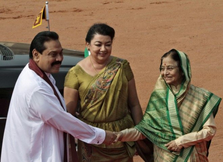 Sri Lanka's President Rajapaksa shakes hands with his Indian counterpart Patil as his wife Shiranthi watches