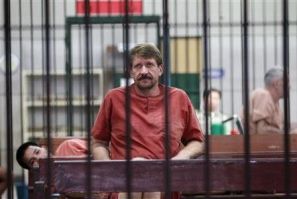 Suspected Russian arms dealer Viktor Bout sits in a holding cell after arriving at a Bangkok criminal court 
