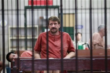 Suspected Russian arms dealer Viktor Bout sits in a holding cell after arriving at a Bangkok criminal court 
