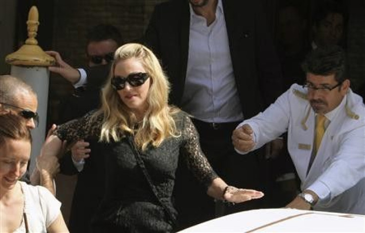 U.S. pop star Madonna, director of movie &#039;&#039;W.E.&#039;&#039;, is helped as she leaves by speedboat at her hotel in Venice during the 68th Venice Film Festival