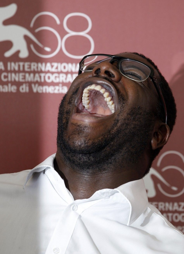 Director Steve McQueen laughs as he poses during a photocall for his film &quot;Shame&quot; at the 68th Venice Film Festival