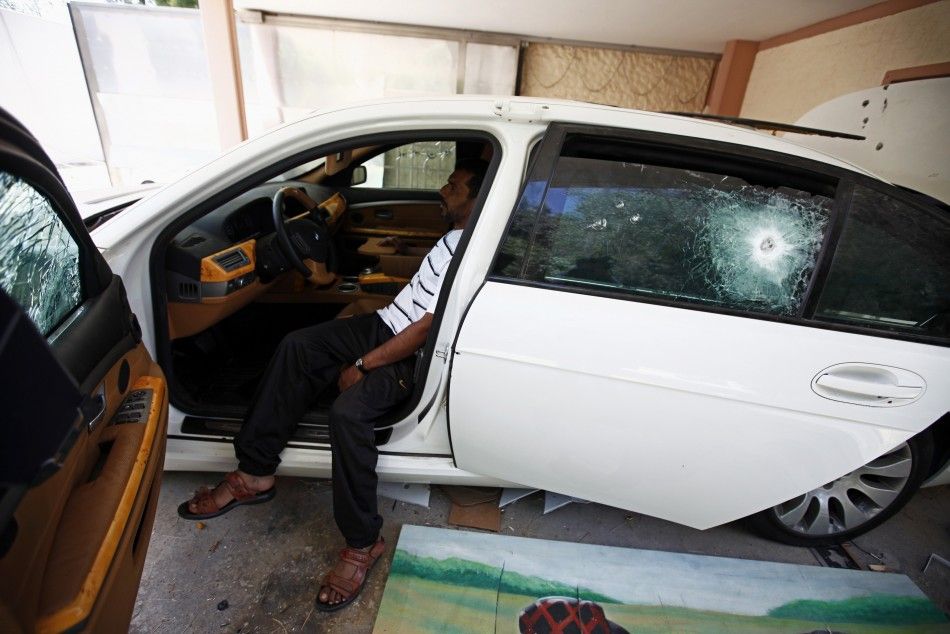 A Libyan sits inside an armoured car at a house belonging to Muammar Gaddafis son Hannibal in Tripoli August 30, 2011. 