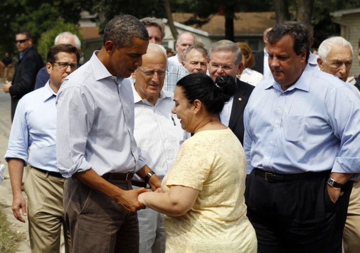 U.S. President Obama holds hands with a woman as he tours damage caused by Hurricane Irene in Wayne, New Jersey