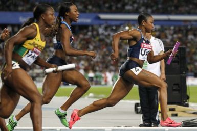 Jeter of the U.S. takes the baton from Myers on their way to winning the women&#039;s 4x100 metres relay final at the IAAF World Championships in Daegu