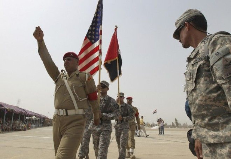 U.S. soldiers from the 4th Stryker Brigade 2nd Infantry Division carry flags during a departure ceremony of U.S. Forces, at Abu Ghraib in Baghdad, August 7, 2010. 