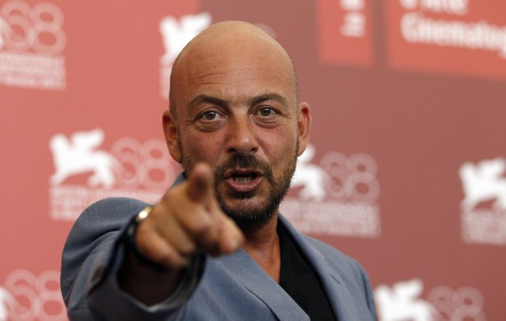 Director Emanuele Crialese points as he poses during a photocall for his film &quot;Terraferma&quot; at the 68th Venice Film Festival