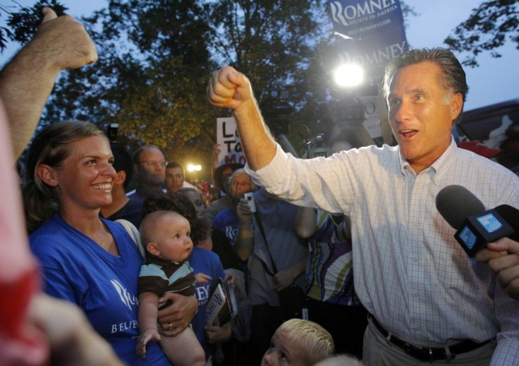 Republican presidential candidate and former Massachusetts Governor Romney fist-bumps a supporter at a rally in Concord