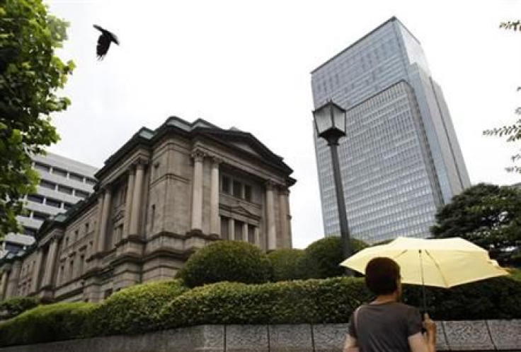 A crow flies near the Bank of Japan headquarters building in Tokyo