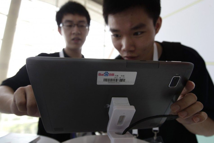 A man uses a tablet computer