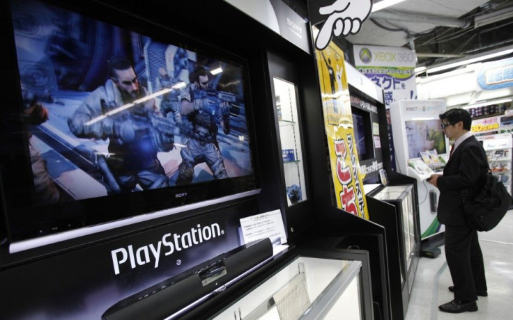 A man plays a game on Sony Corp&#039;s PlayStation 3 game console at an electronic store in Tokyo