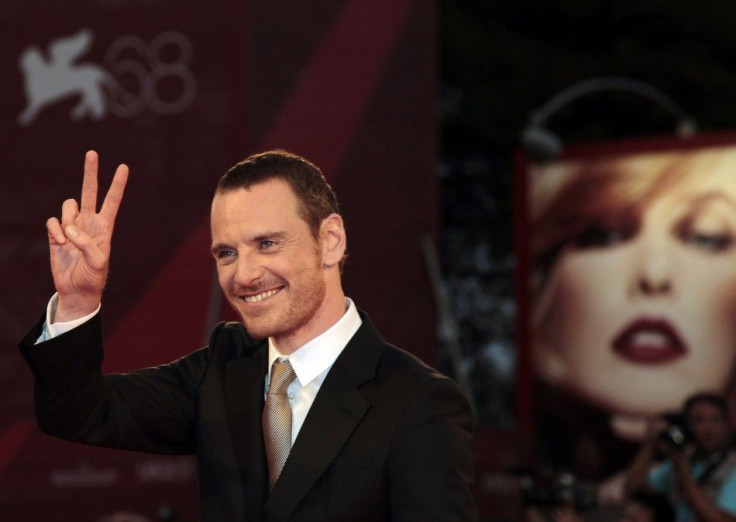 Actor Fassbender gestures as he arrives on red carpet for film &quot;A Dangerous Method&quot; at 68th Venice Film Festival