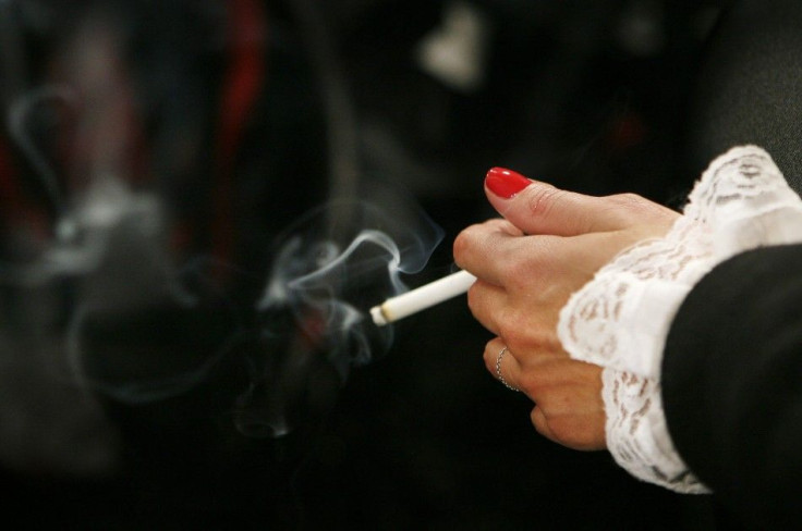 A model smokes backstage before the start of the Jenni Kayne fall fashion show during New York Fashion Week