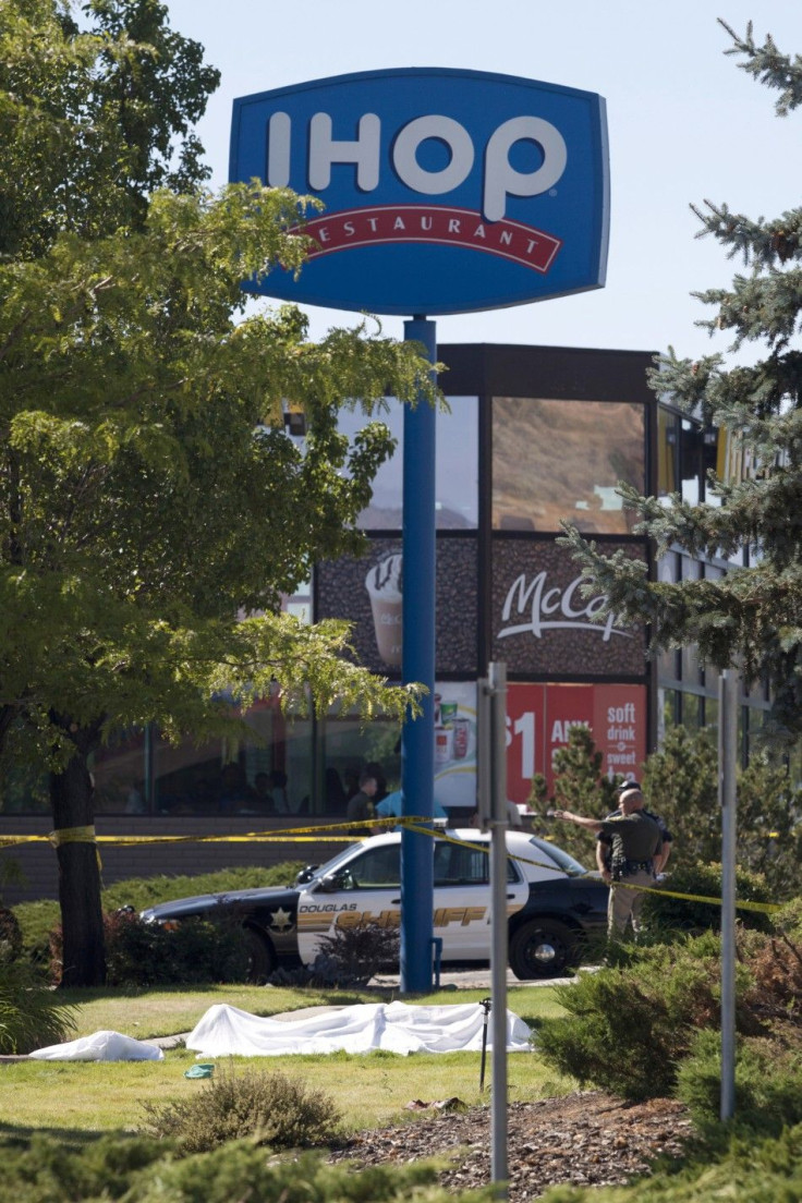 The body of a shooting victim covered with a sheet lies on the front lawn of an IHOP restaurant in Carson City, Nevada, as sheriffs secure the crime scene