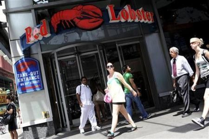 Passersby walk in front of the Times Square Red Lobster restaurant in New York