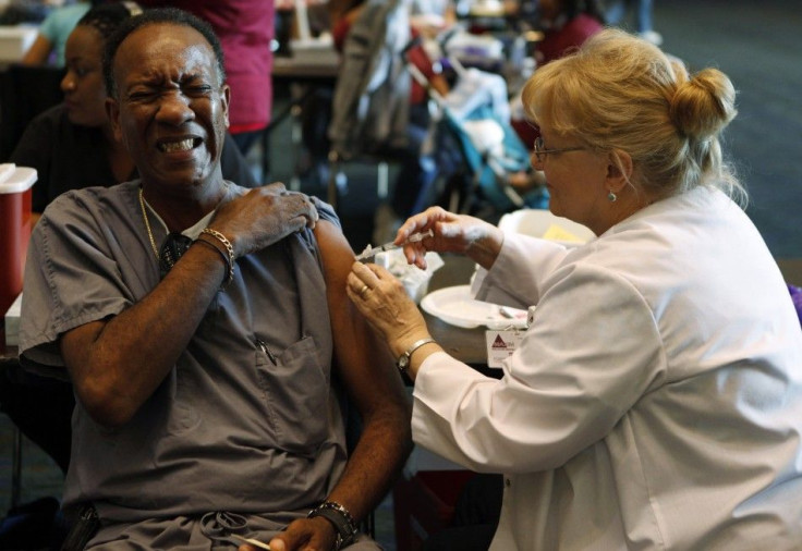 Larry Anderson reacts as he gets a shot of the H1N1 flu vaccination in Arlington