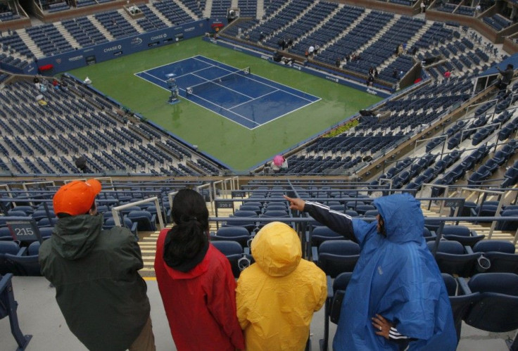 Patrons look down on the court at Arthur Ashe Stadium after rain postponed play in the U.S. Open tennis tournament in New York