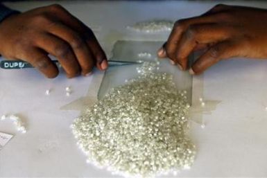 A worker at the Botswana Diamond Valuing Company displays rough diamonds