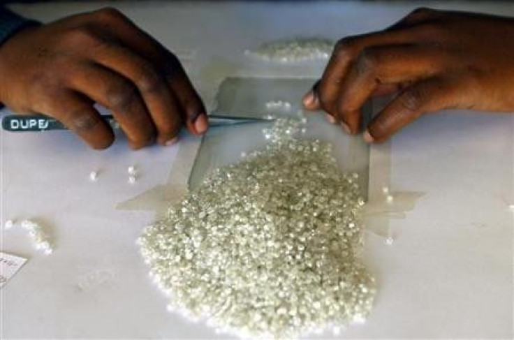 A worker at the Botswana Diamond Valuing Company displays rough diamonds