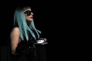 U.S. singer Lady Gaga holds a tea cup as she arrives at a news conference in Tokyo
