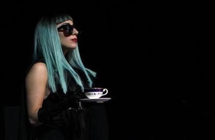 U.S. singer Lady Gaga holds a tea cup as she arrives at a news conference in Tokyo