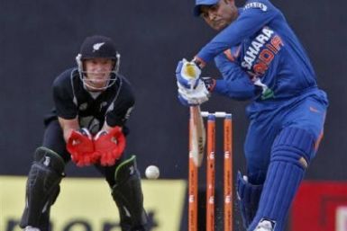 Virender Sehwag (R) plays a shot as New Zealand's wicketkeeper Gareth Hopkins watches during the sixth one-day international cricket match in the tri-series in Dambulla August 25, 2010. 