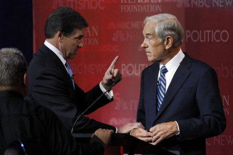 Texas Governor Perry talks during a break with Rep. Ron Paul on stage at the Reagan Centennial GOP presidential primary debate in Simi Valley