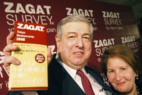 Zagat Survey co-founders Tim and Nina Zagat pose with the latest version of their guide to Tokyo restaurants at a news conference in Tokyo