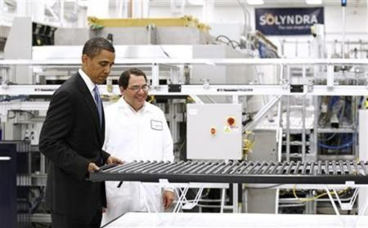 U.S. President Barack Obama lifts a solar panel as he tours Solyndra, Inc., a solar panel manufacturing facility in Fremont, California