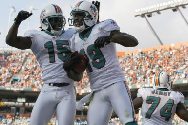 Miami Dolphins Davone Bess celebrates with teammate Brandon Marshall after Marshall scored a touchdown against the Buffalo Bills during fourth quarter NFL football game in Miami
